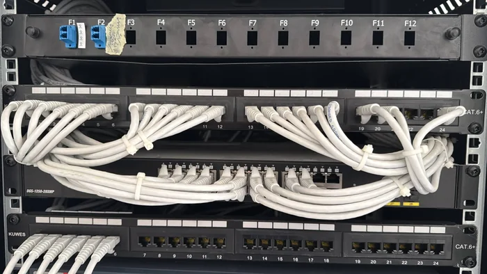 Structured cabling patch panels and network switch in an ELV rack